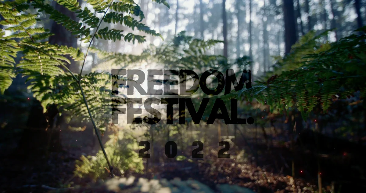 Freedom Festival 2022 title over woodland