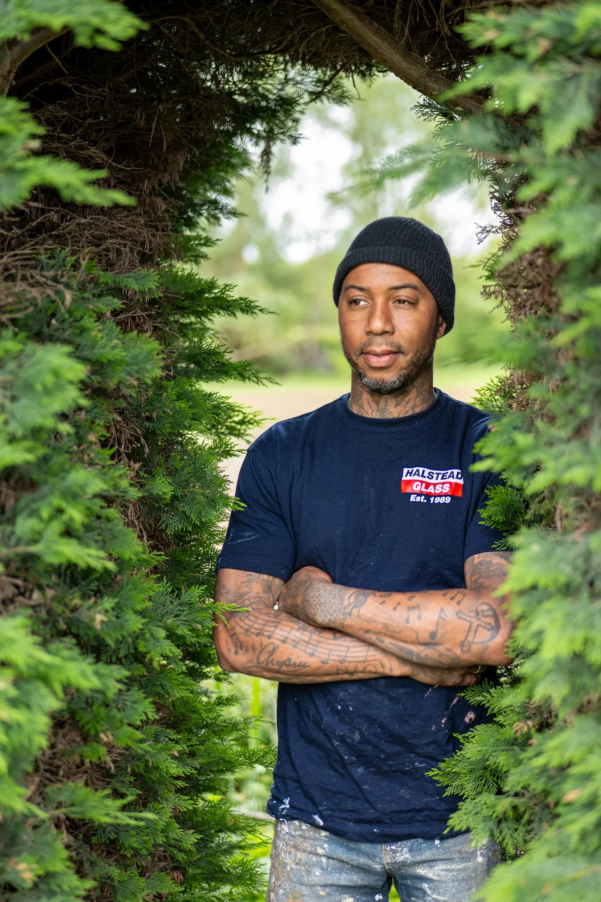 A Halstead Glass team member framed by trees outdoors