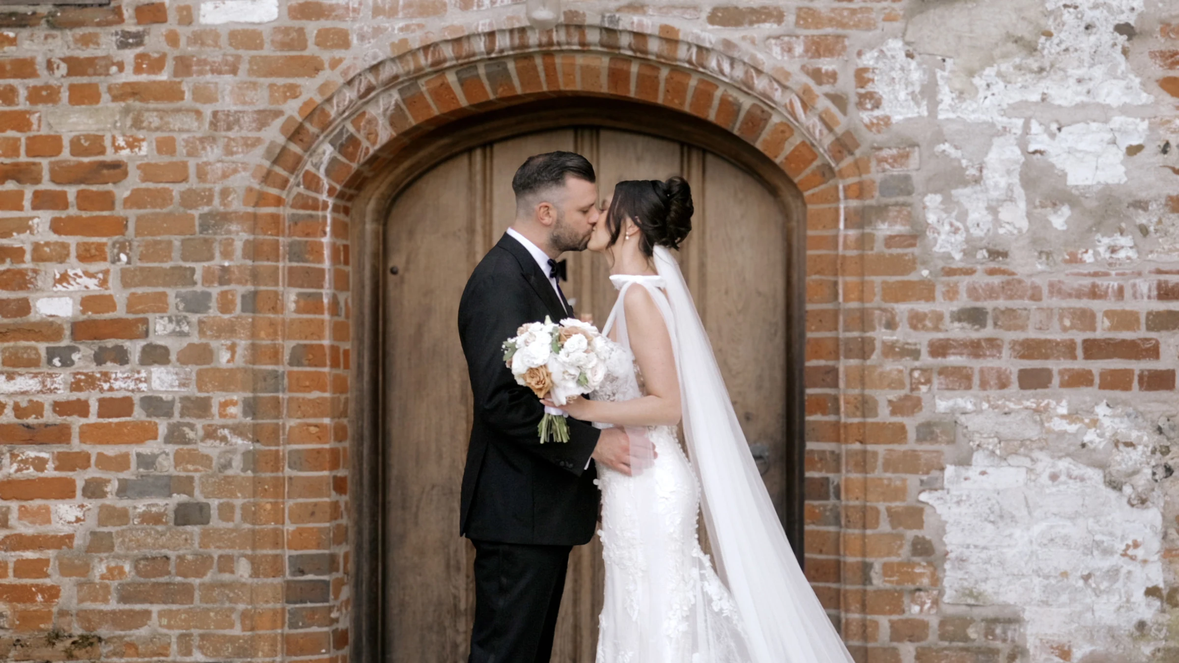Rachel and Nik outside the barn at Bruisyard Country Estate