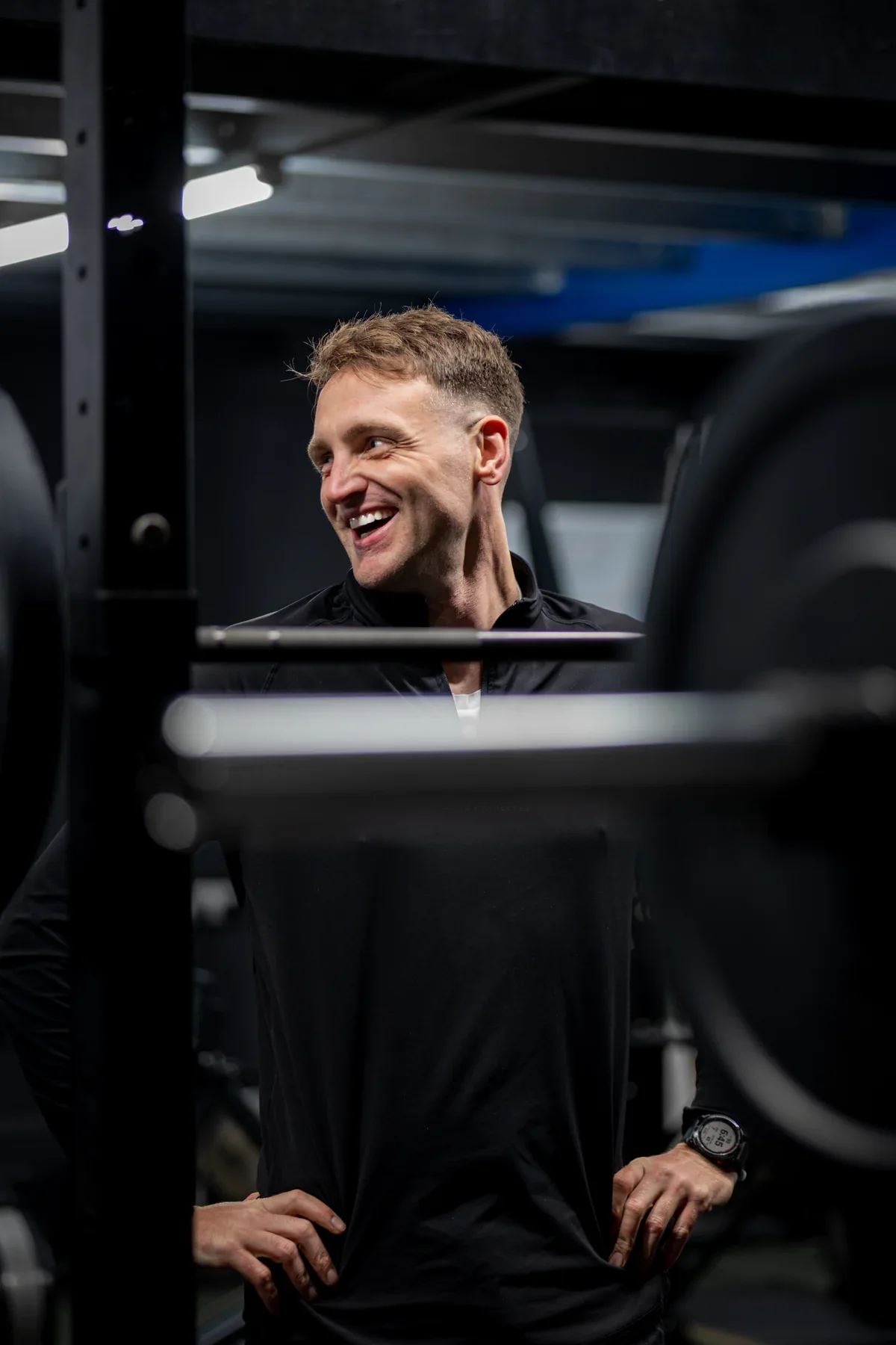 A smiling member of the Vertex Pro Fitness team in the gym